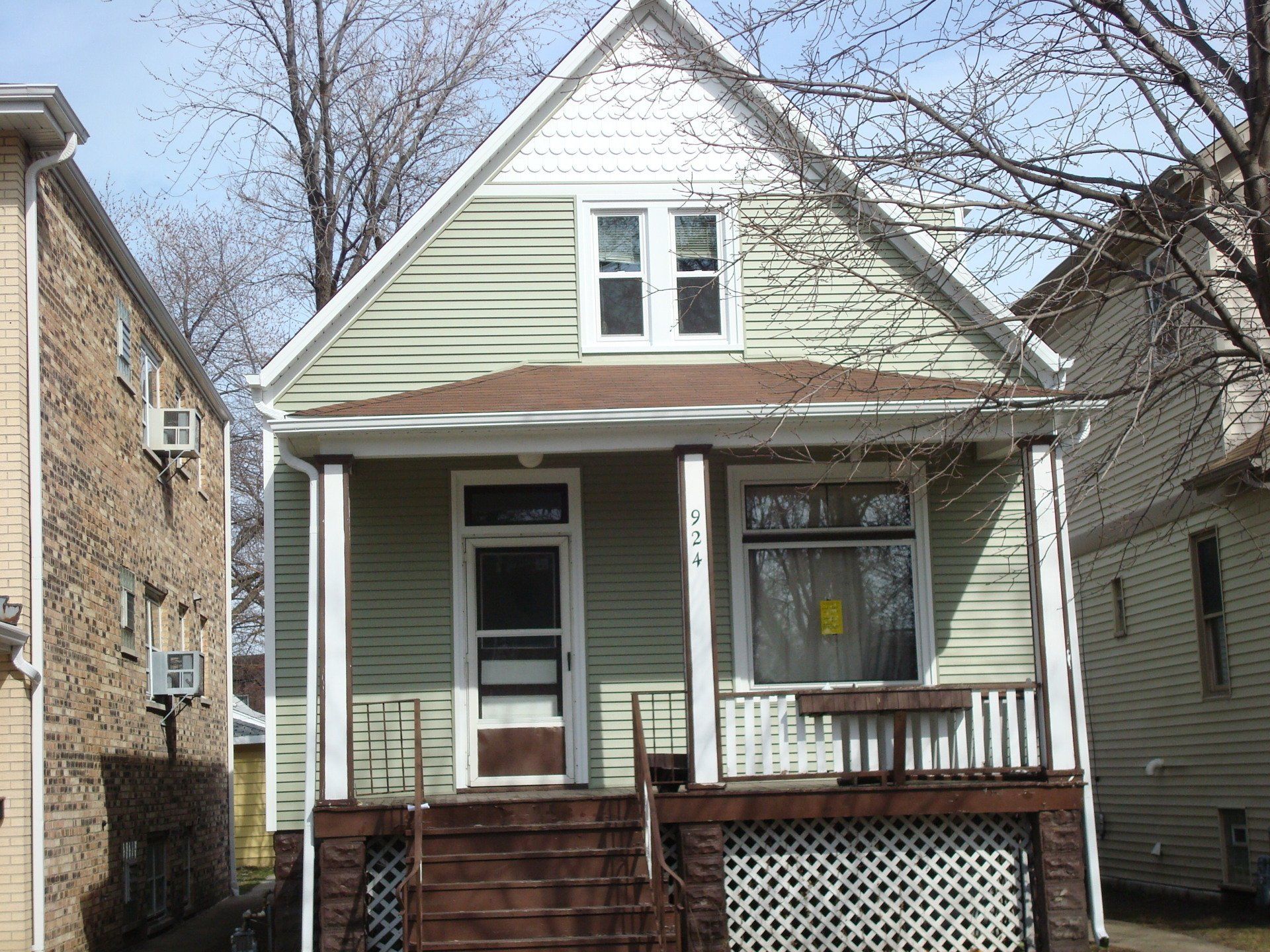 A small house with a porch and stairs