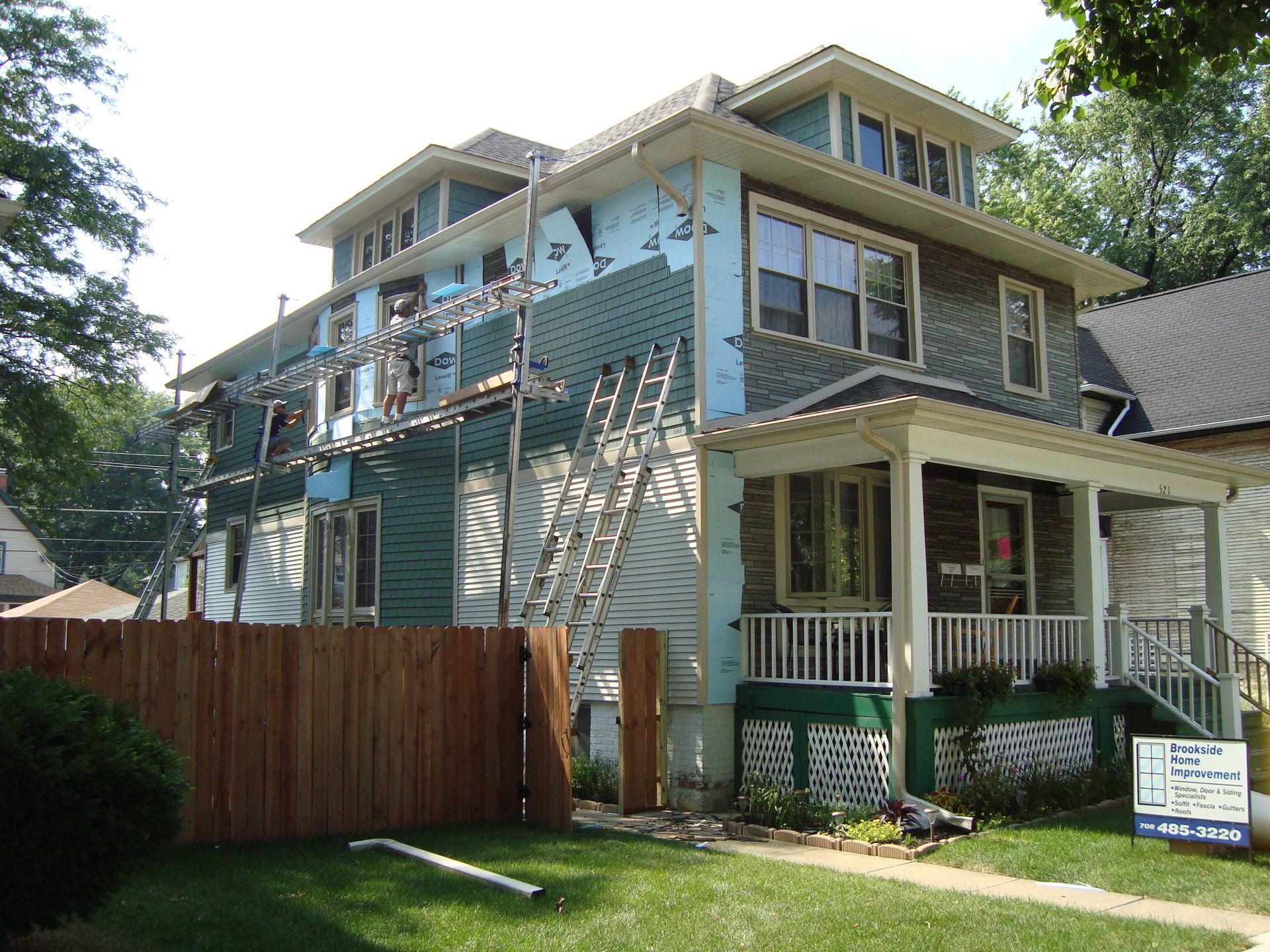 A house that is being remodeled with a sign in front of it