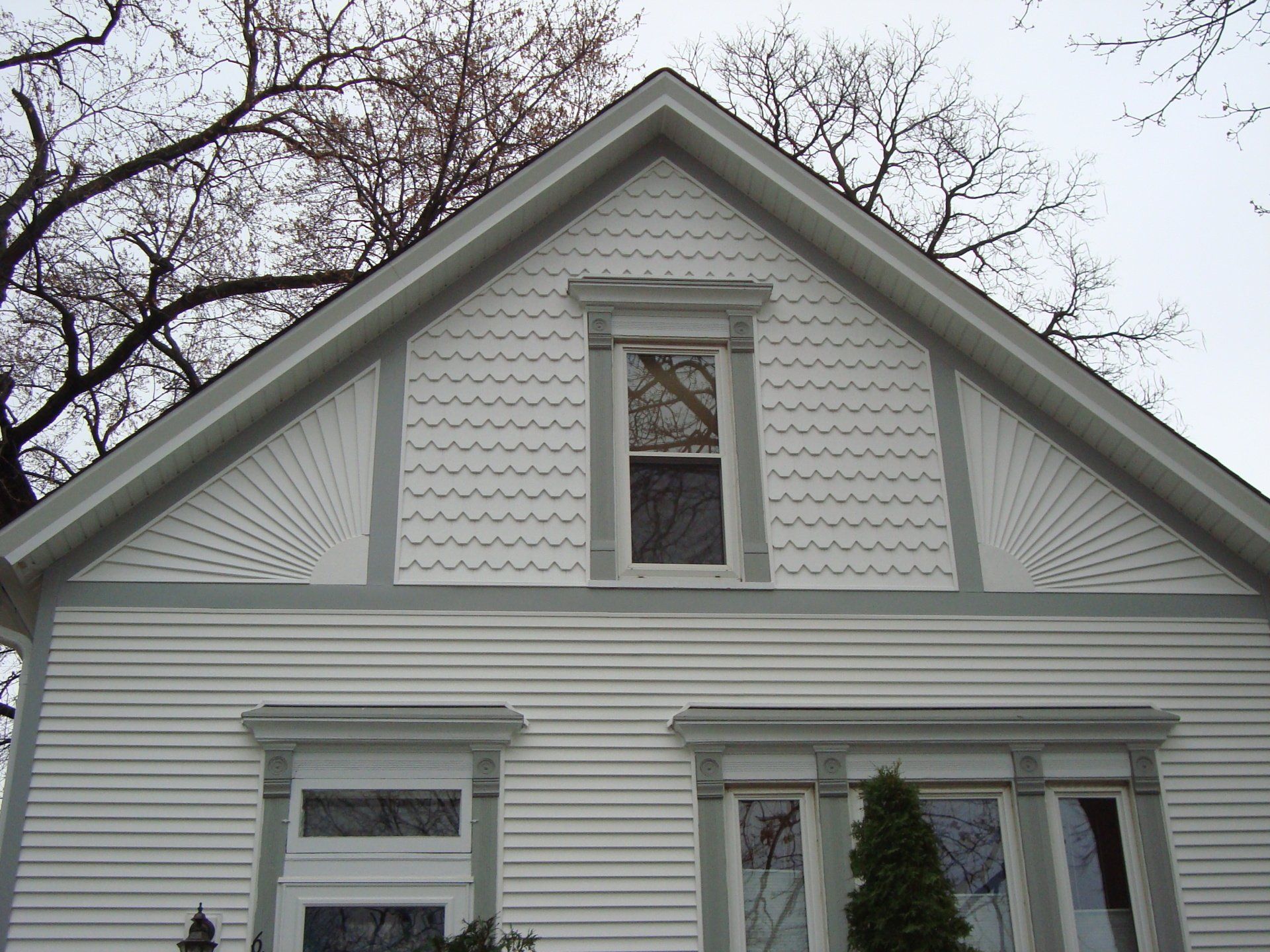 A white house with a vaulted roof and a window