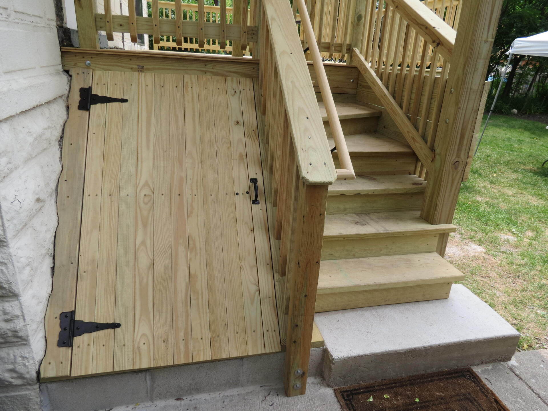 A wooden deck with stairs and a wooden gate