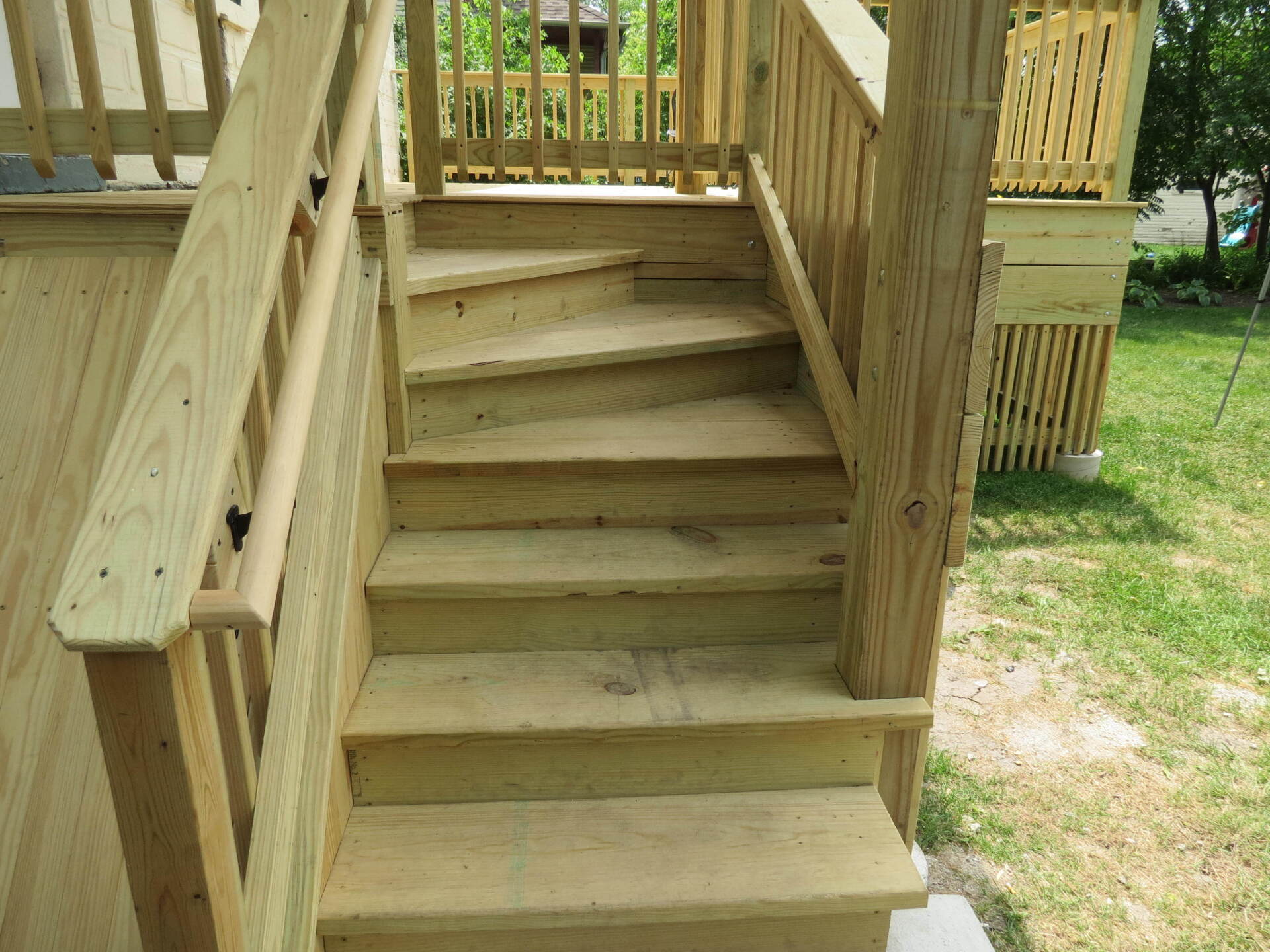 A set of wooden stairs leading up to a deck