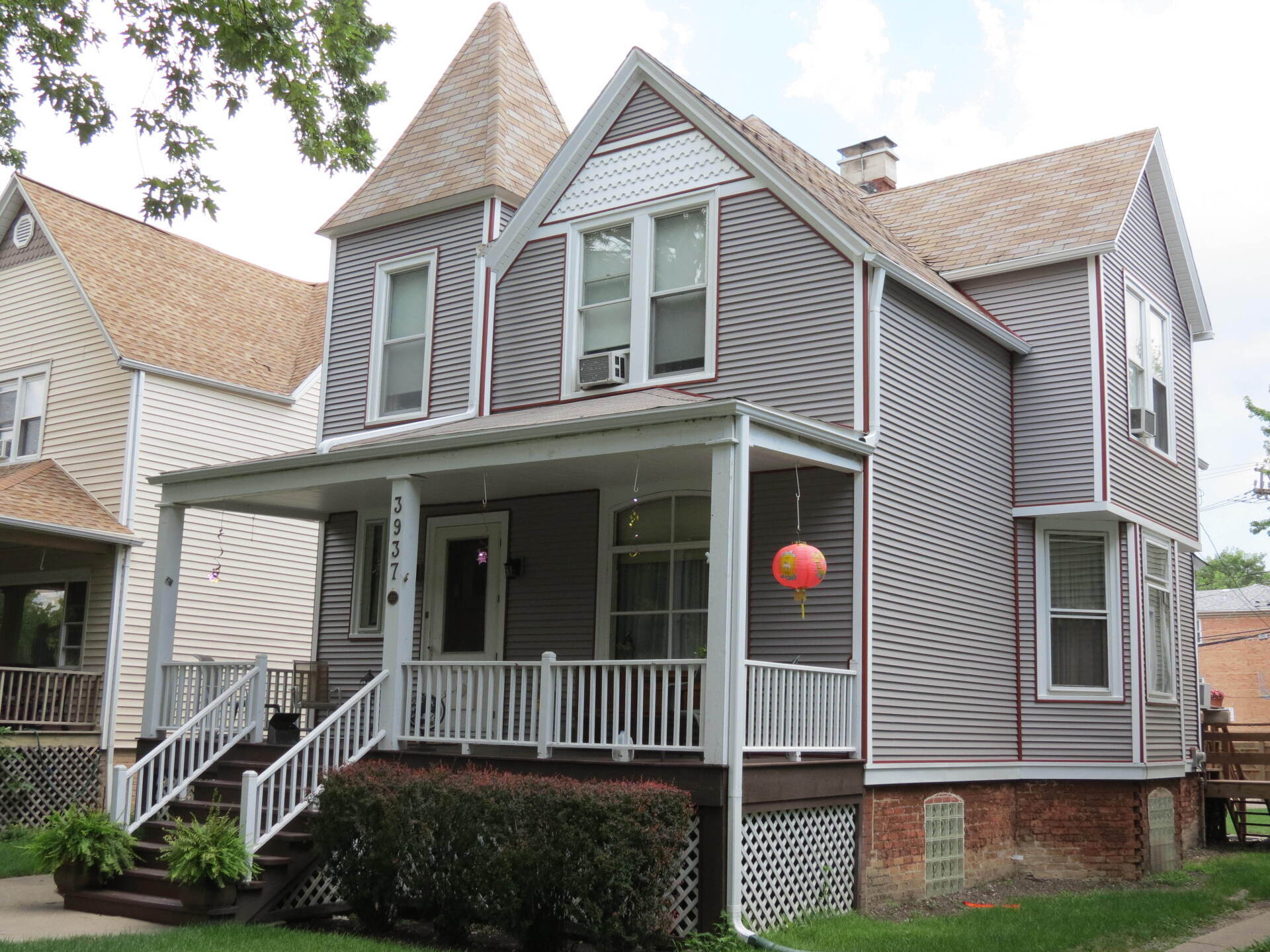 A large house with a large porch and stairs
