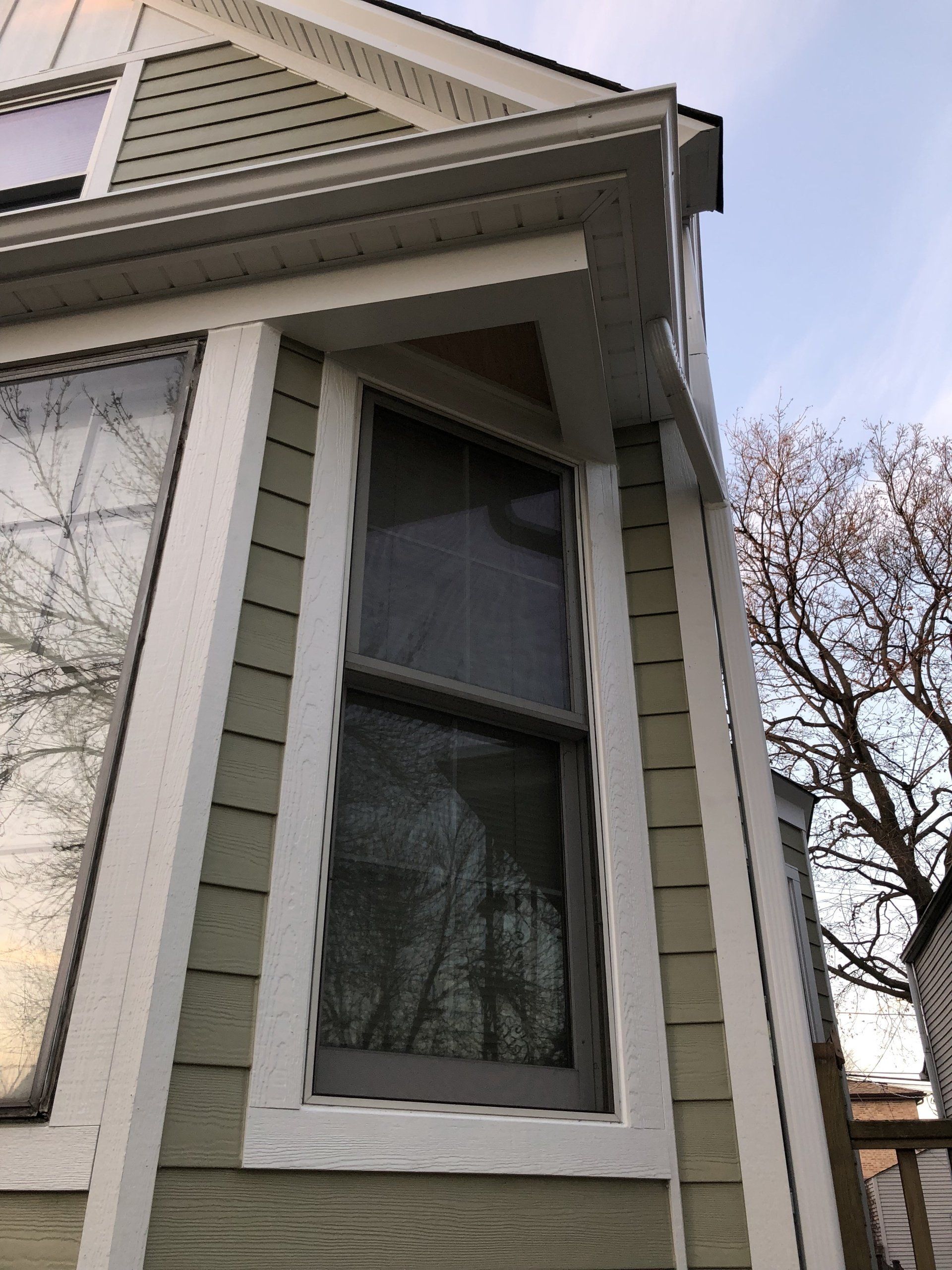 A house with a large window on the side of it