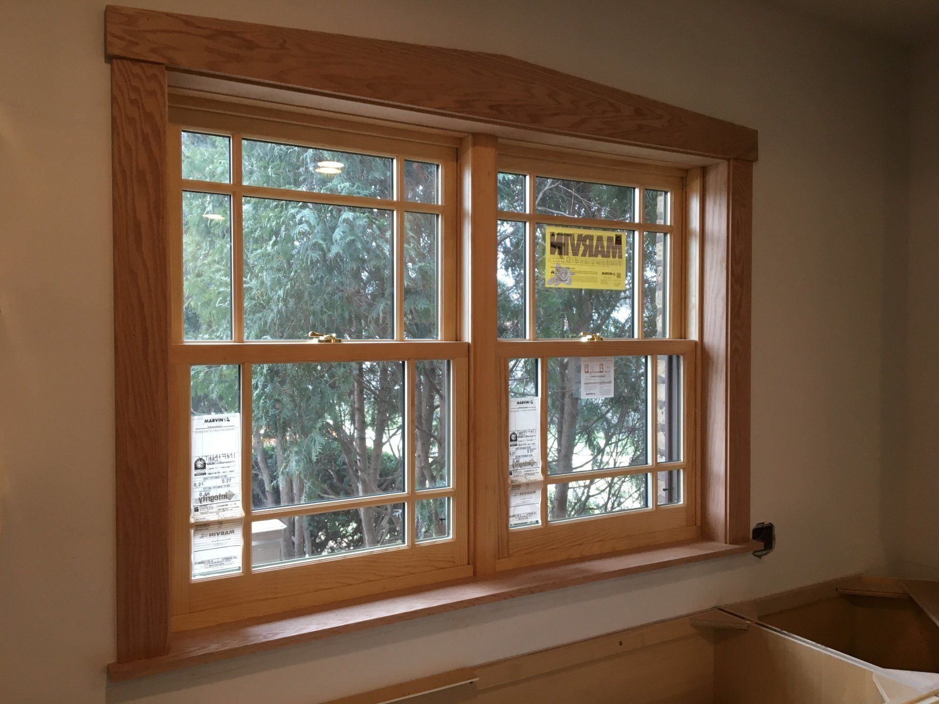 A wooden window with a warning sign on it