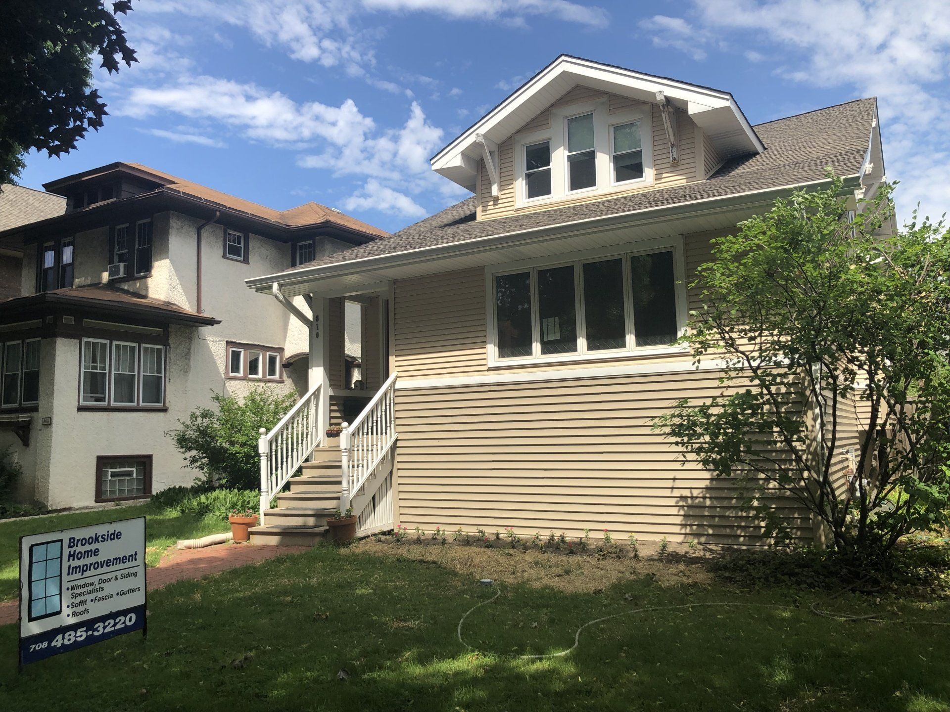 A house with a for sale sign in front of it