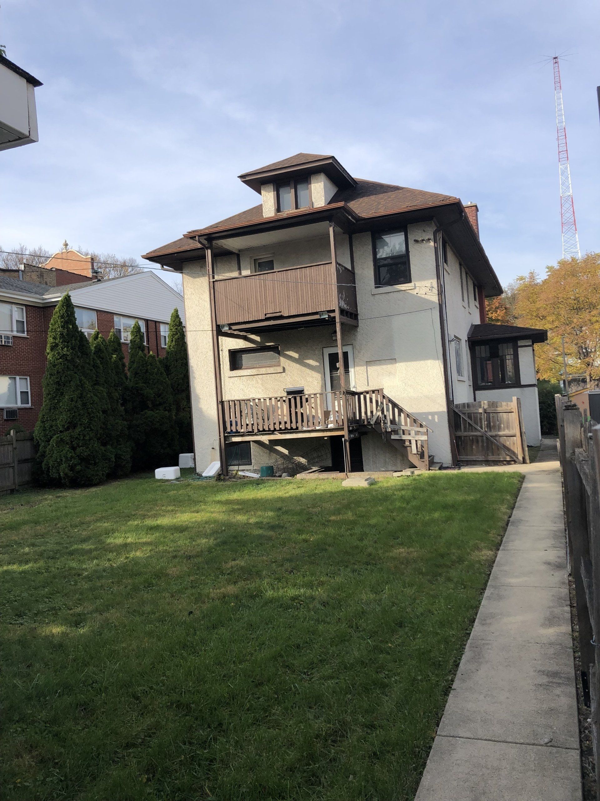 A large white house with a large lawn in front of it