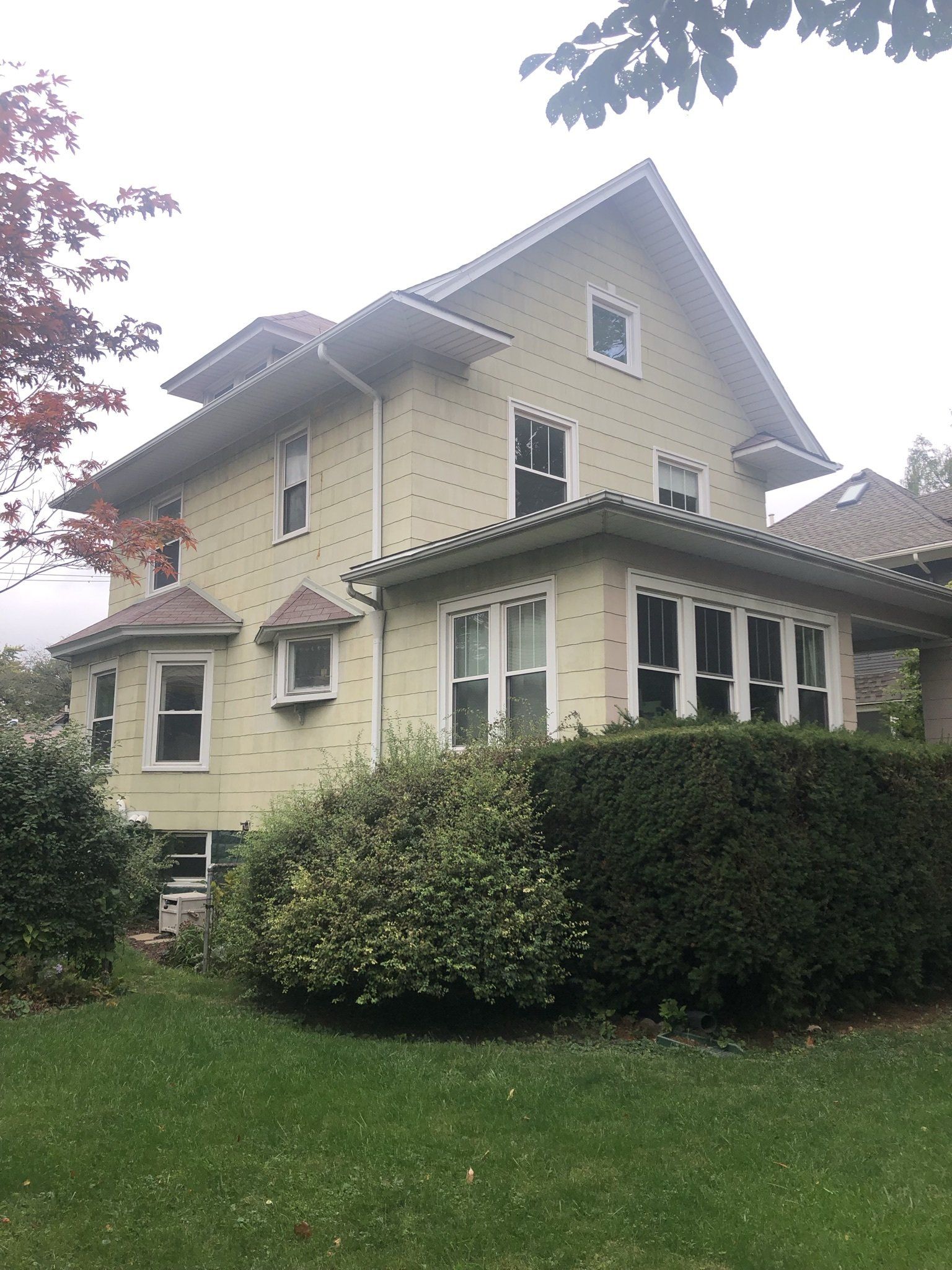 A large yellow house with a lot of windows