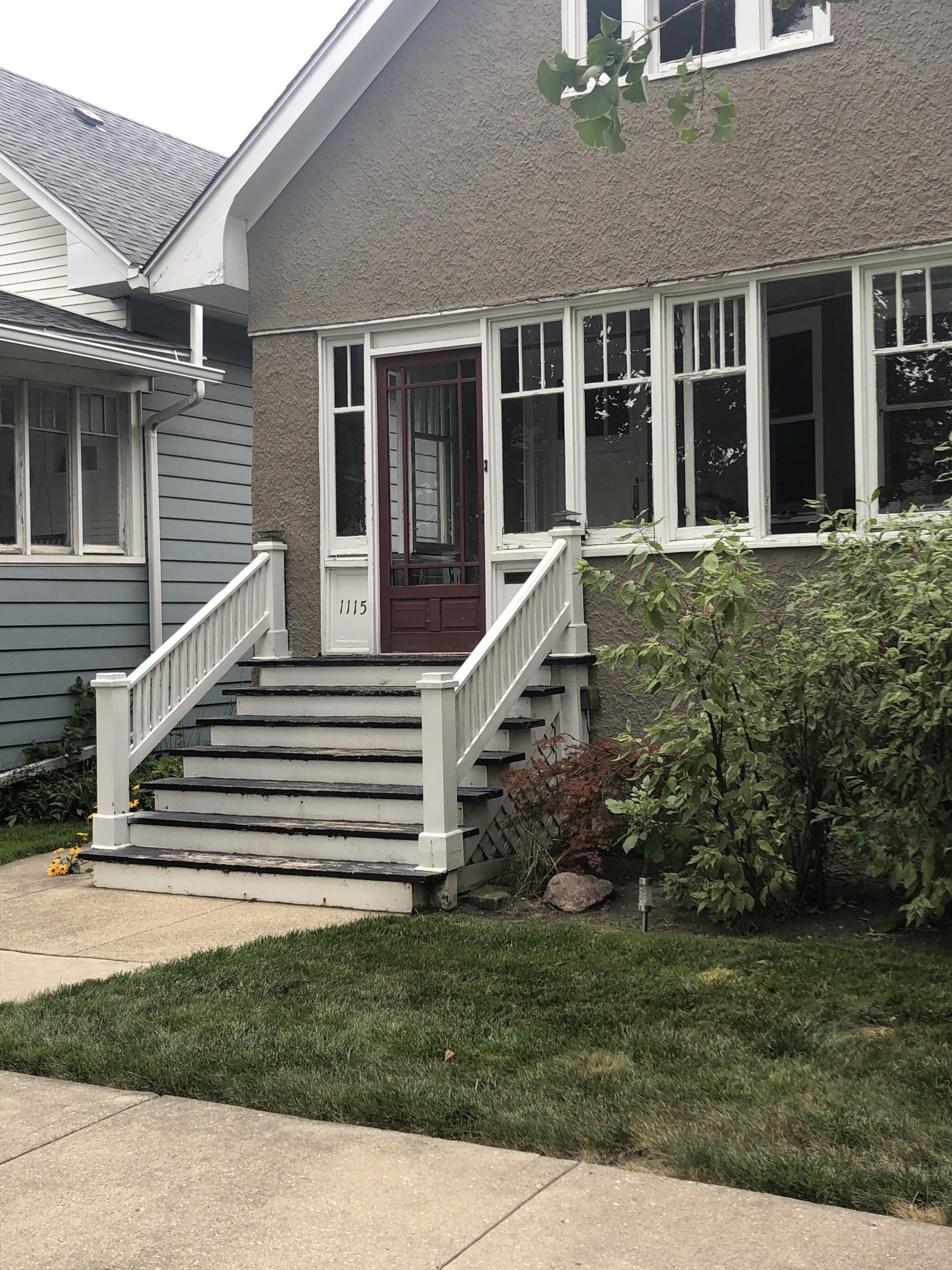 A house with stairs leading up to the front door