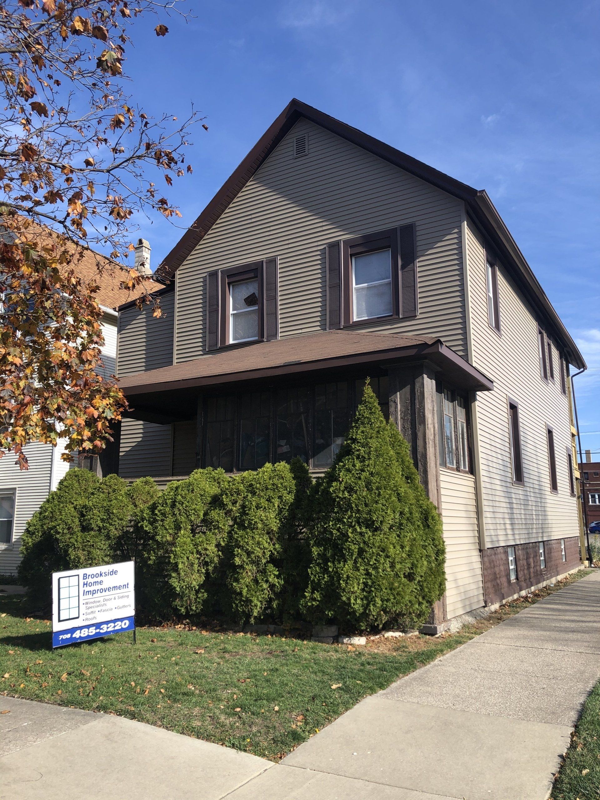 A house with a for sale sign in front of it