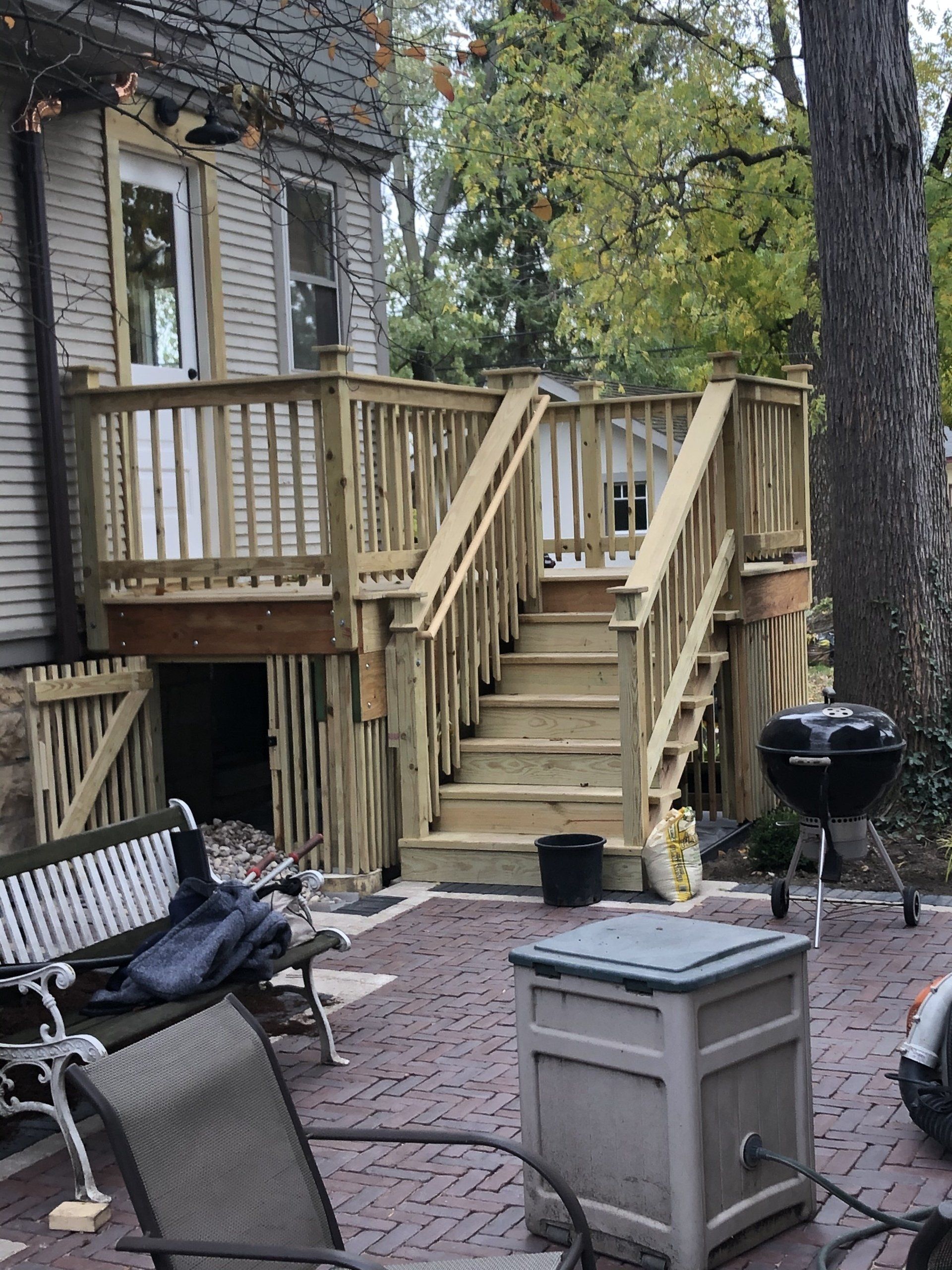 A wooden deck with stairs leading up to it