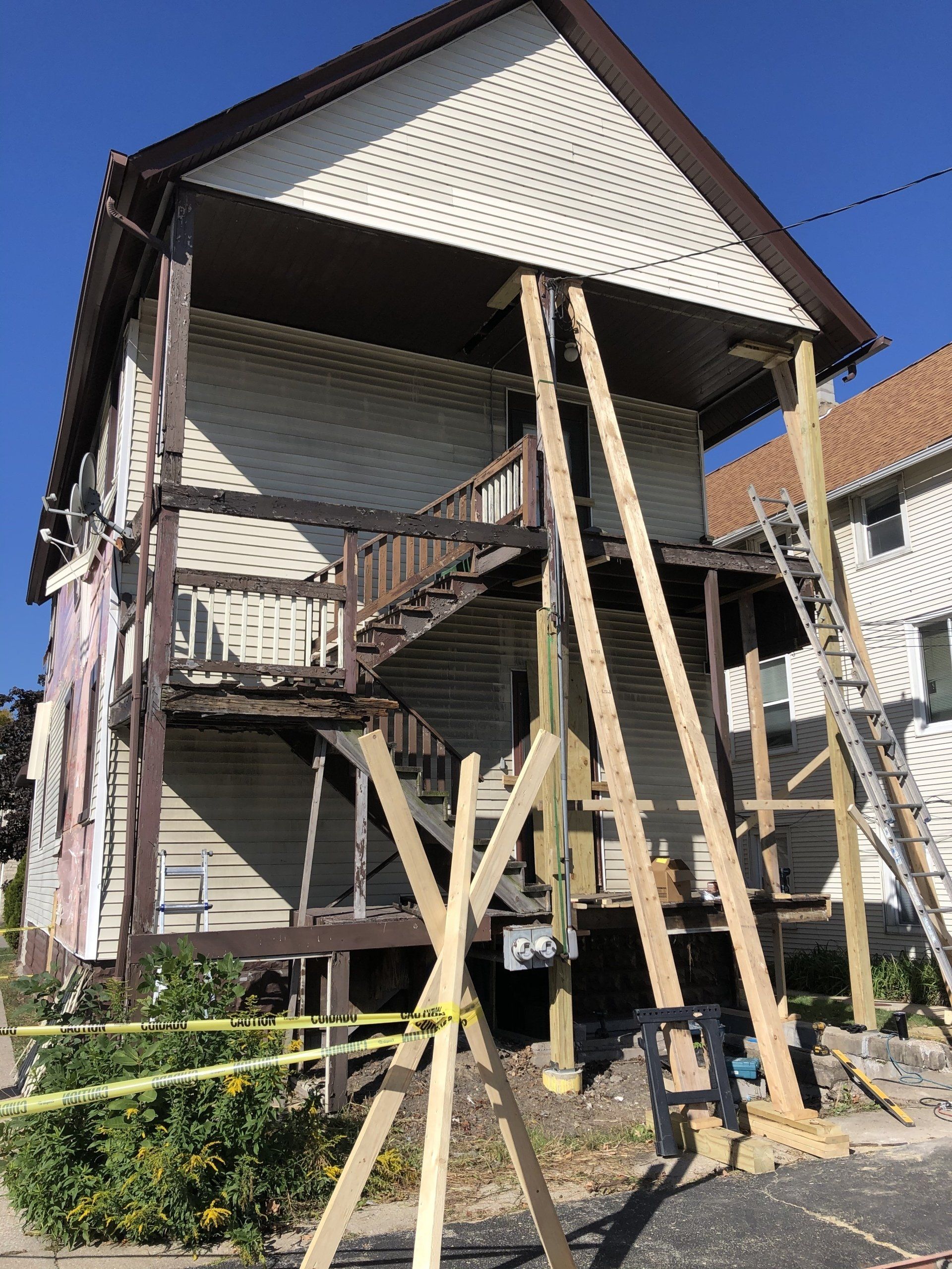 A house that is being remodeled with wooden scaffolding around it