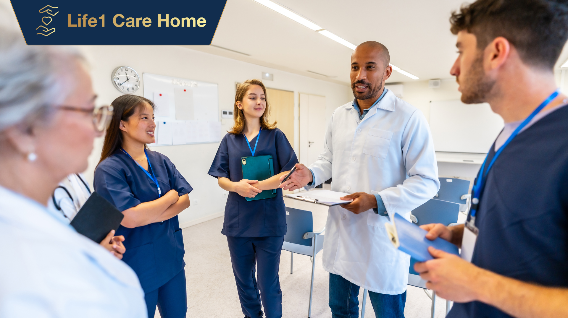 Medical professionals in scrubs and lab coats having a meeting indoors.