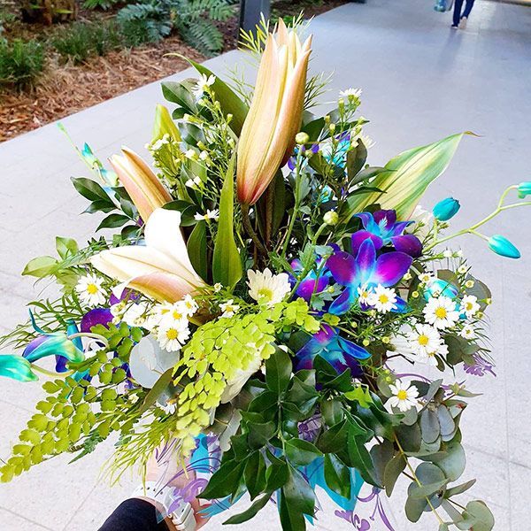 A Person Is Holding a Bouquet in Their Hand — Ivy Lane Flowers & Gifts in Buderim, QLD