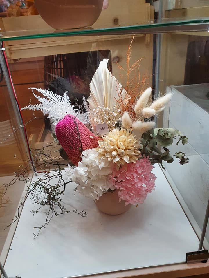 A Vase Filled with Flowers Is Sitting on Top of A Glass Display Case — Ivy Lane Flowers & Gifts in Maroochydore, QLD