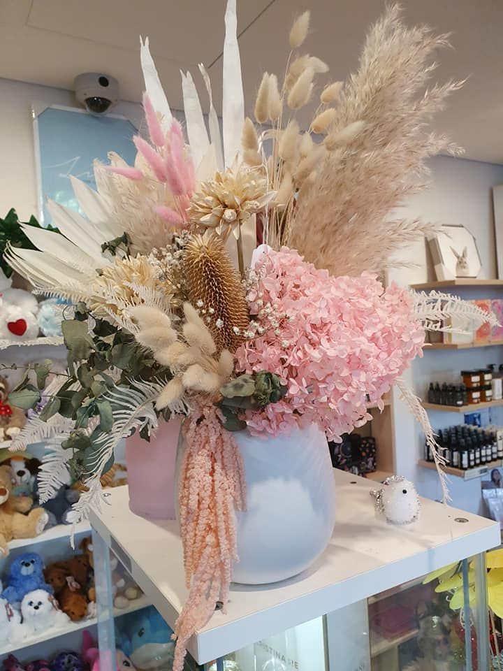A Vase Filled with Pink and White Flowers Is Sitting on A Table — Ivy Lane Flowers & Gifts in Buderim, QLD