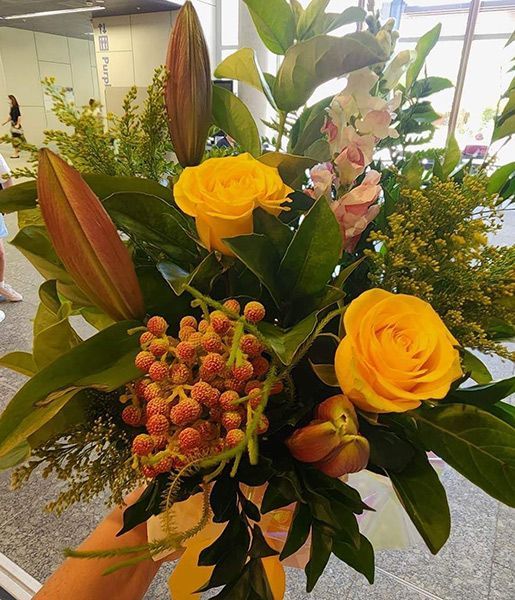 A Person Is Holding a Bouquet of Yellow Flowers — Ivy Lane Flowers & Gifts in Maroochydore, QLD