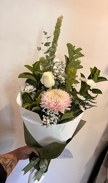 A Person Is Holding a Bouquet in Their Hand — Ivy Lane Flowers & Gifts in Caloundra, QLD