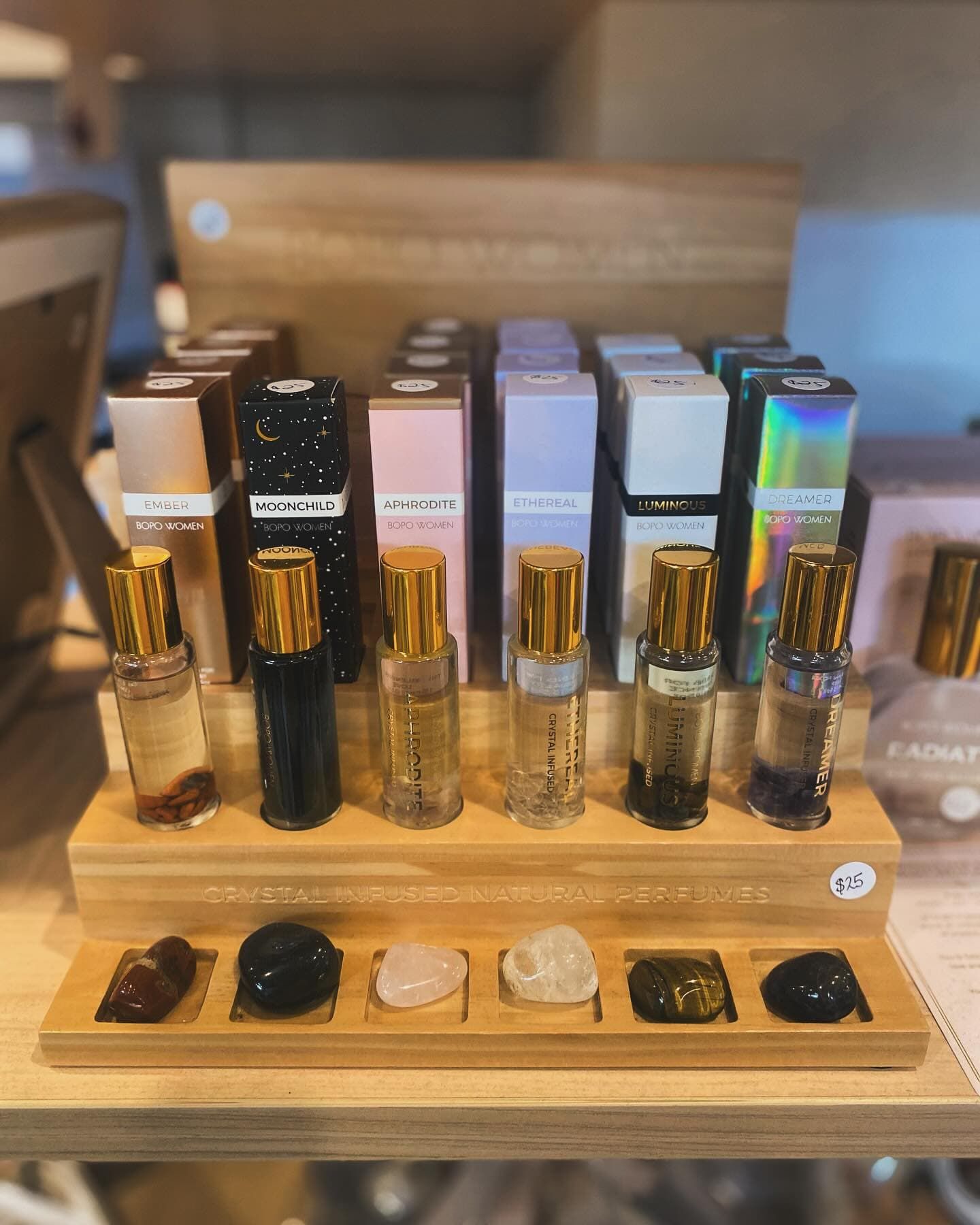 A Display of Perfume Bottles and Crystals on A Wooden Shelf — Ivy Lane Flowers & Gifts in Birtinya, QLD