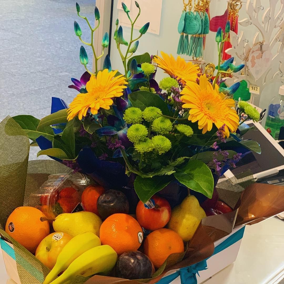 A Box Filled with Fruits and Flowers with A Blue Ribbon — Ivy Lane Flowers & Gifts in Sunshine Coast, QLD