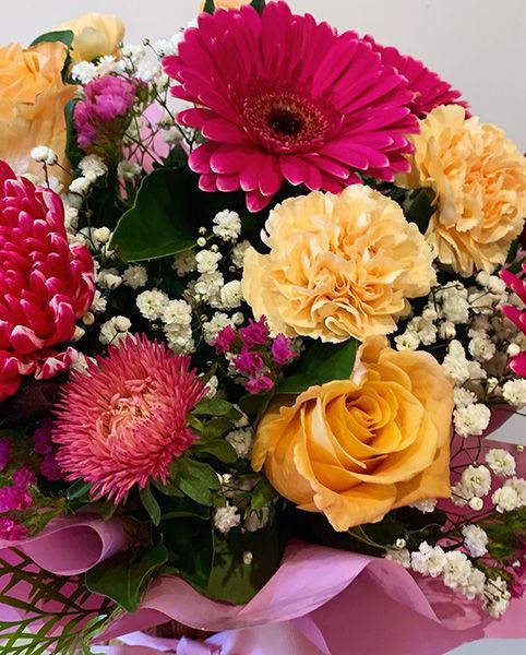 A Bouquet of Pink and Yellow Flowers Wrapped in Pink Paper — Ivy Lane Flowers & Gifts in Buderim, QLD
