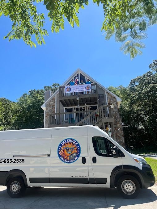 White van with logo parked in front of a stone building with a balcony. Sunny day.