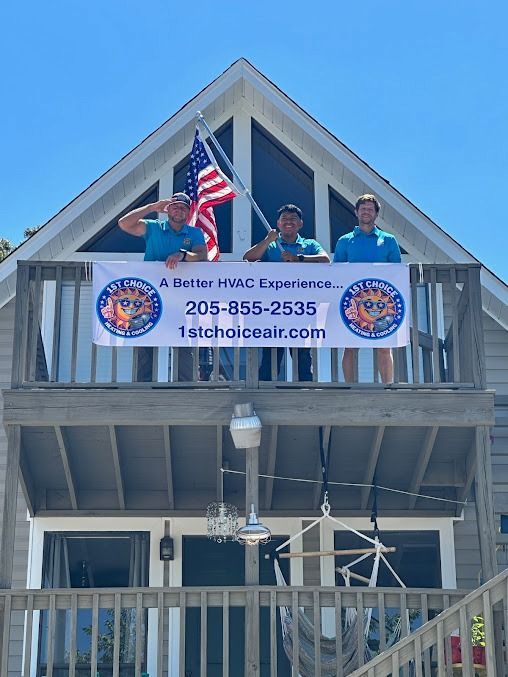 Three men on a wooden deck hold a banner for 