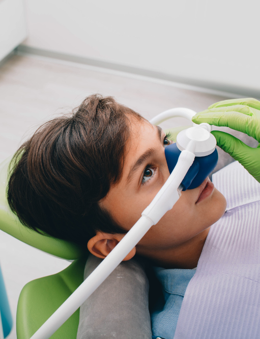 Kid with sedation mask on in dentist chair | Best family dentist for children and adults in Somerset, NJ