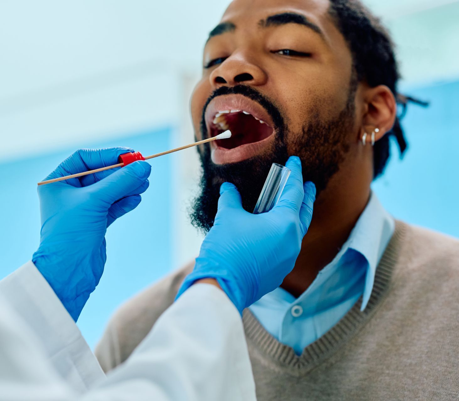 man at dentist getting mouth swabbed | Oral microbiome testing from our biological dentist 