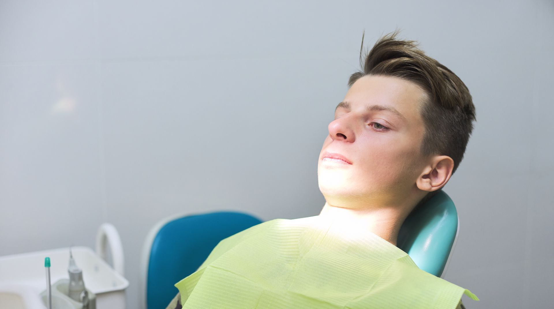 teenager anxious in dental chair | Sedation options for crowns, gum disease therapy, and implants | Somerset, NJ