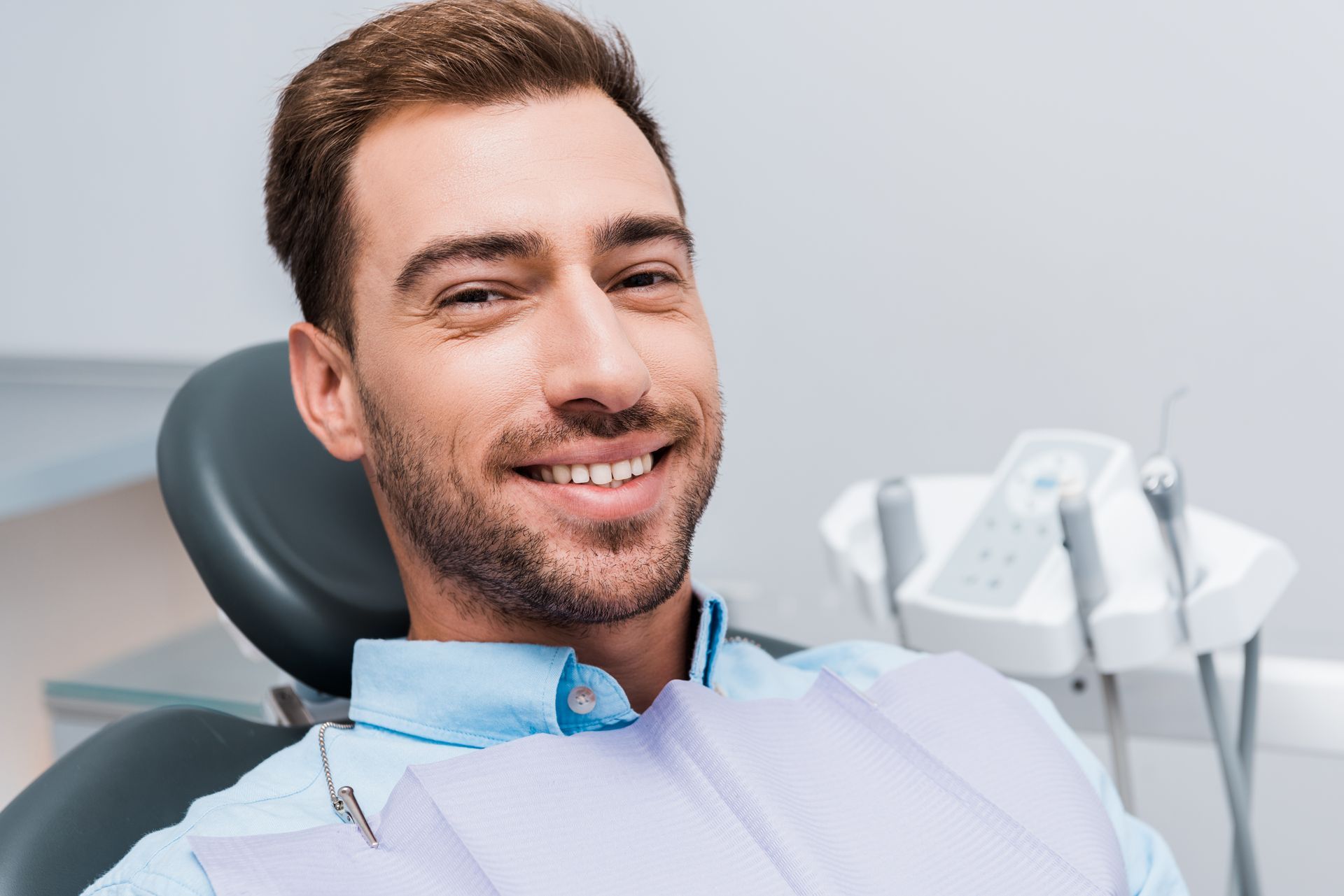 Man smiling after getting dentures at our family dentist in Somerset, NJ