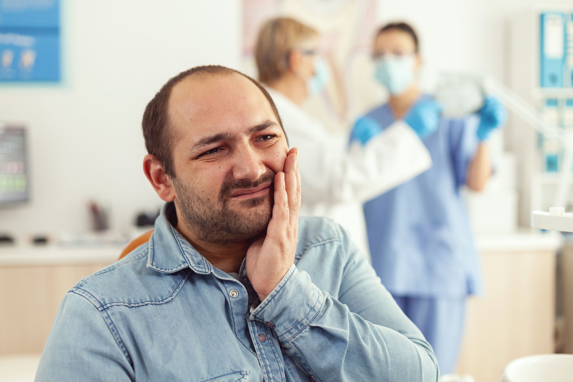 man holding cheek | Ozone therapy at our family dentist in Somerset, NJ