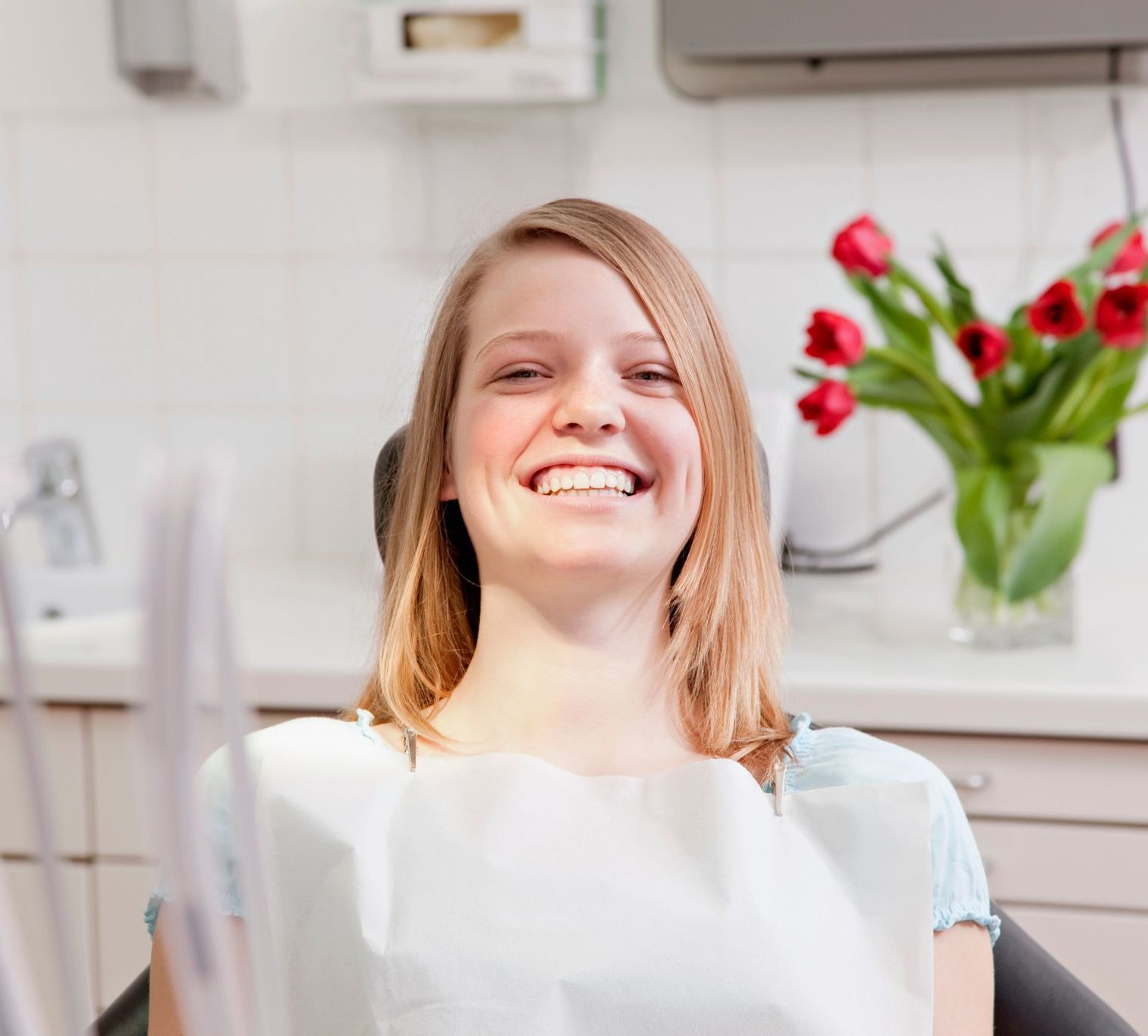 woman smiling in dentist chair because of biological dentistry in Somerset, NJ.