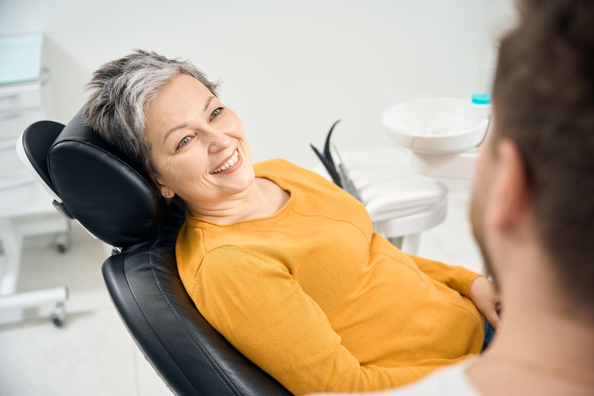 woman smiling during dental procedure for crowns and fillings | Cigna, Aetna, MetLife | Somerset, NJ