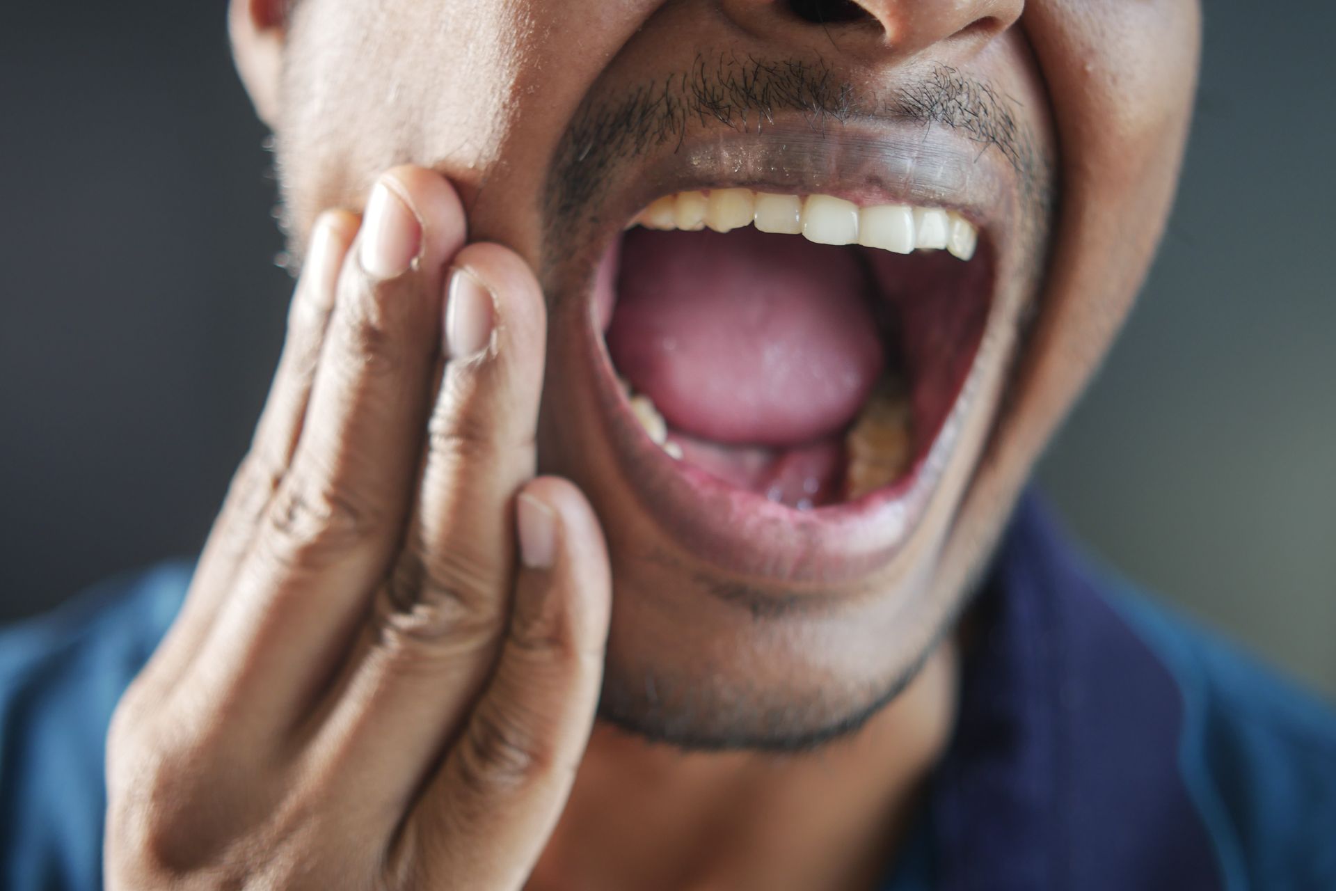 Man holding mouth | Same day emergency dentist near Somerset, NJ