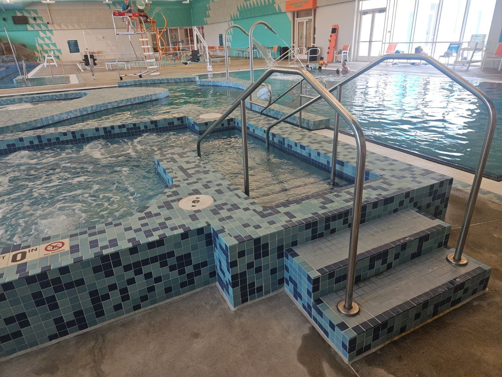 A swimming pool with stairs leading up to it.
