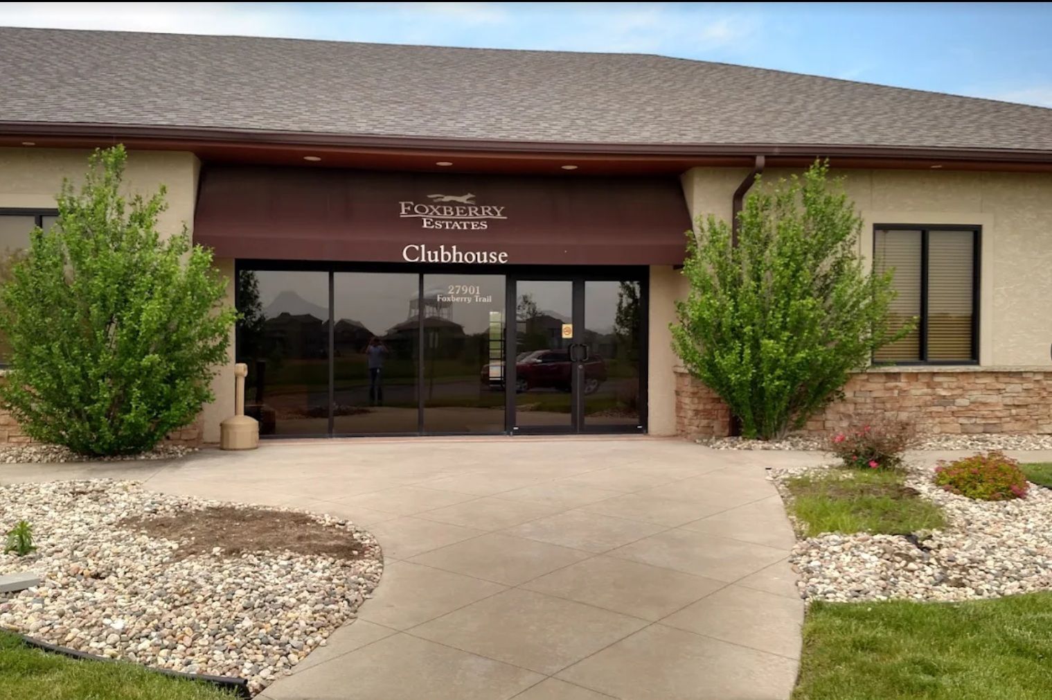 A building with a brown awning that says clubhouse on it