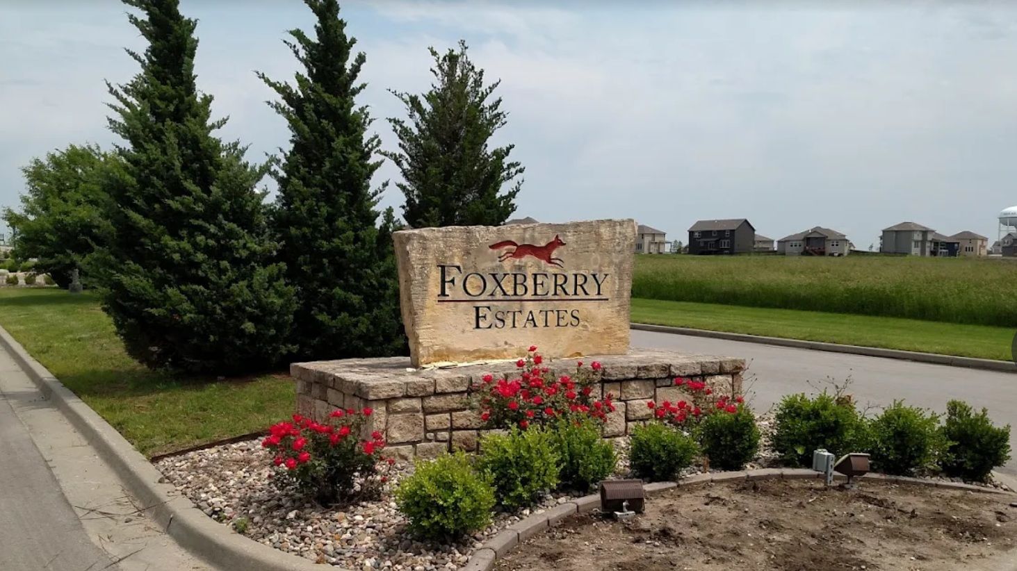 A stone sign that says foxberry estate on it