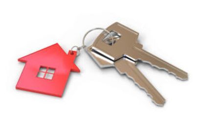 A pair of keys with a red house keychain attached to them