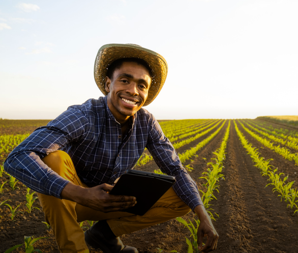 Woman with arms crossed, wearing blue polka dot shirt, standing outside a building, looking directly at the camera.