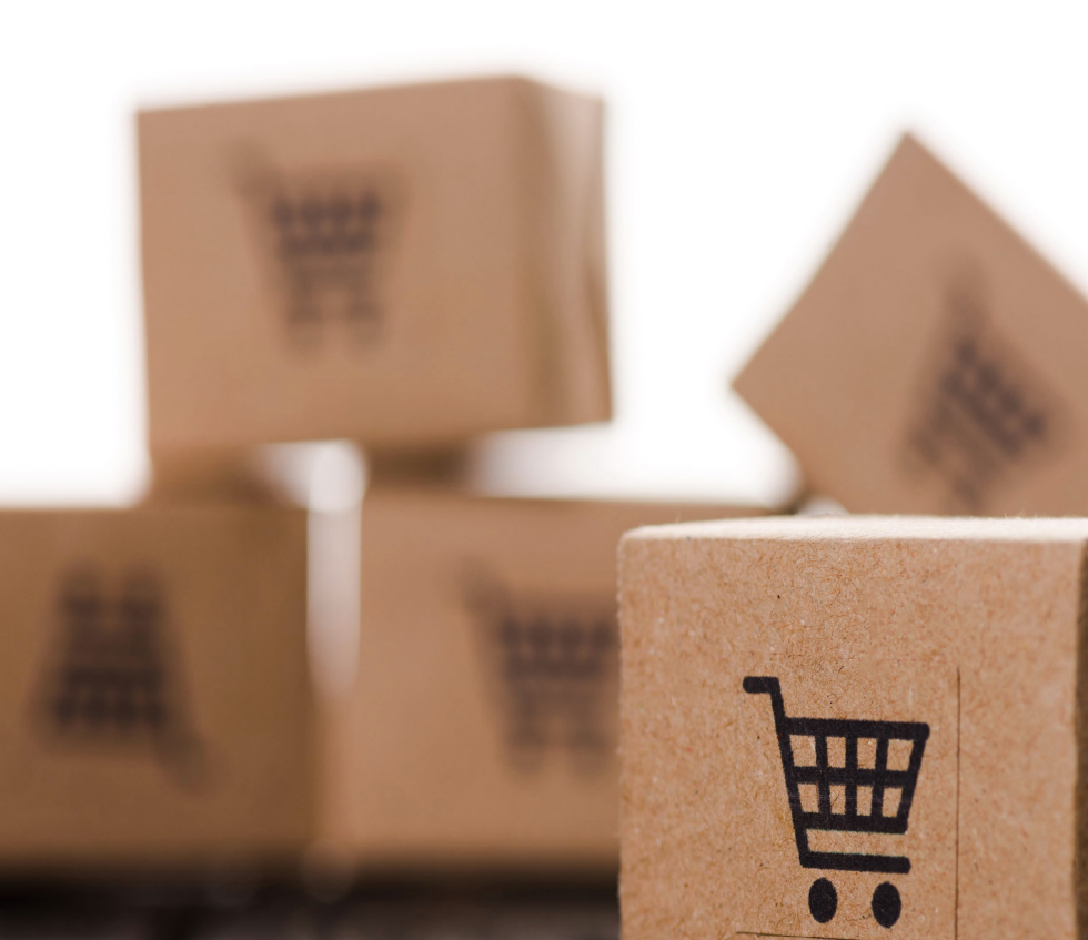 Woman with arms crossed, wearing blue polka dot shirt, standing outside a building, looking directly at the camera.