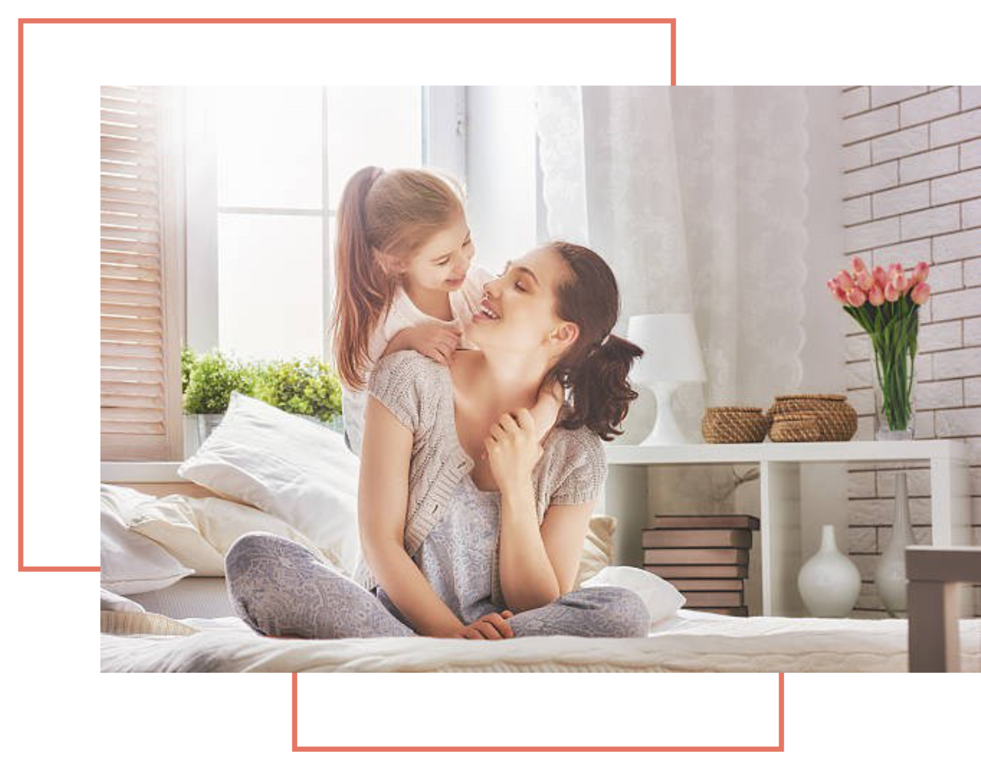 A woman and a little girl are sitting on a bed.