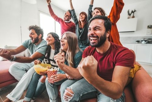 Friends watching football together at home