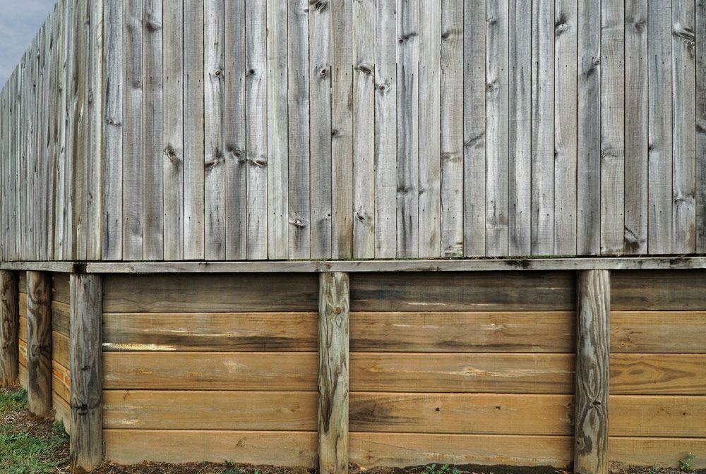 Professionally Built Wooden Fence Above a Retaining Wall — Fencer in Wauchope, NSW