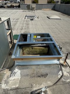 A skylight is sitting on top of a roof.