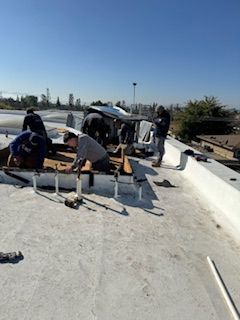 A group of men are working on a roof.