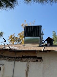 A man is working on the roof of a building.