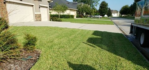 Fertilization — Man Using a Lawn Mower in Jacksonville, FL
