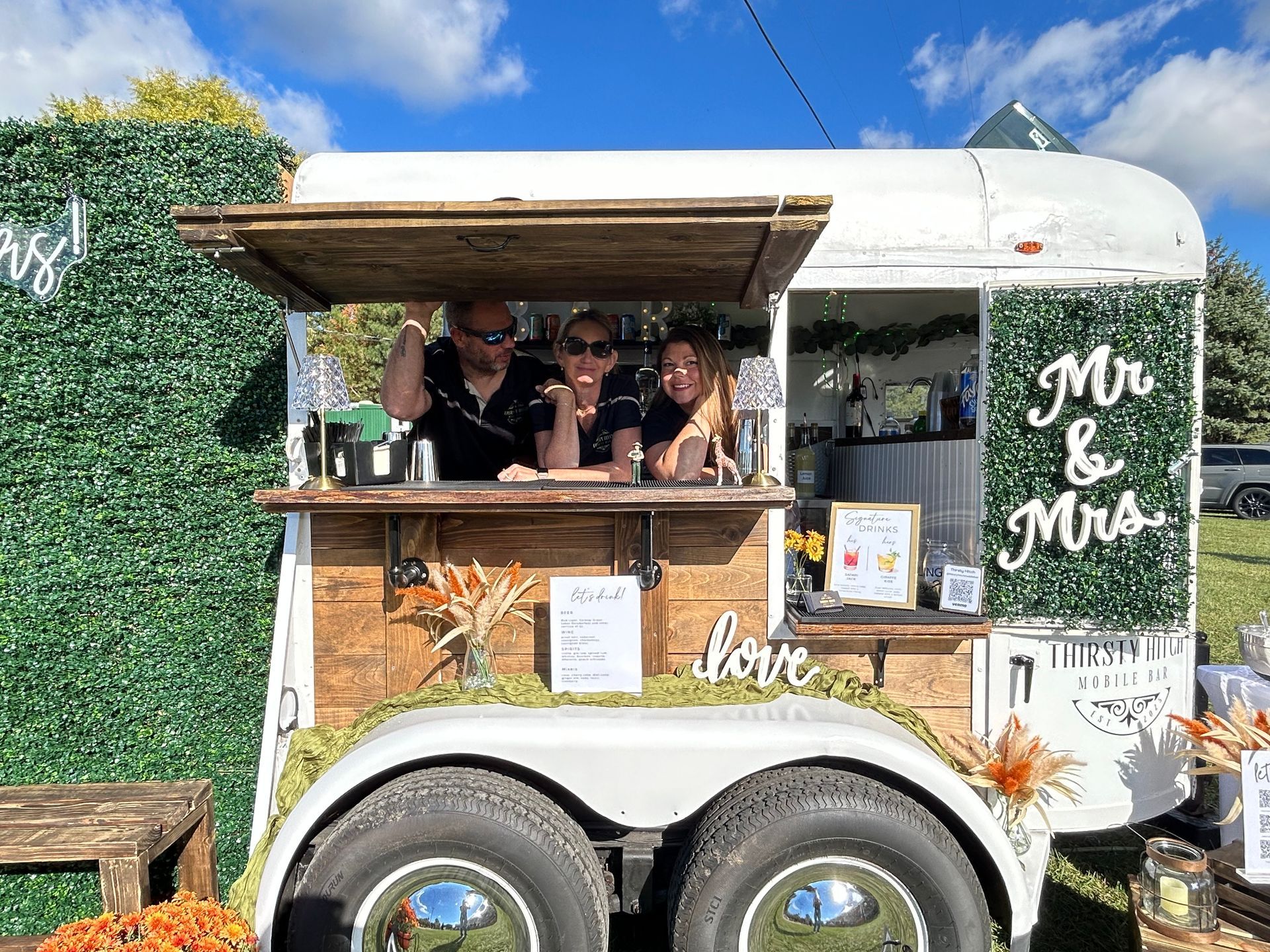 Mobile bar in a converted horse trailer with staff.