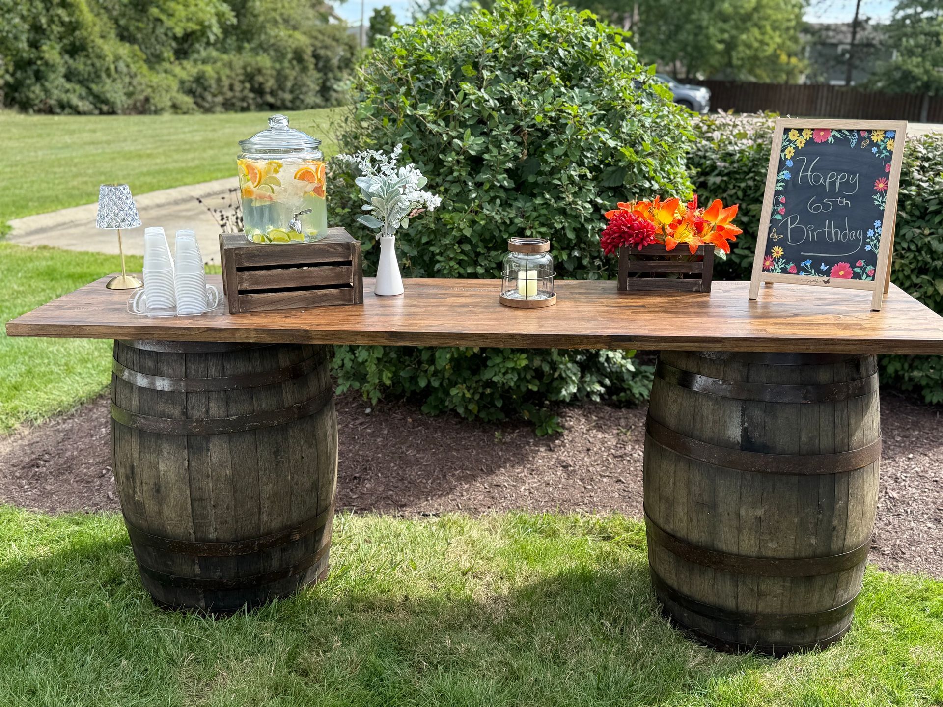 Three colorful cocktails, garnished, sit on a marble bar.
