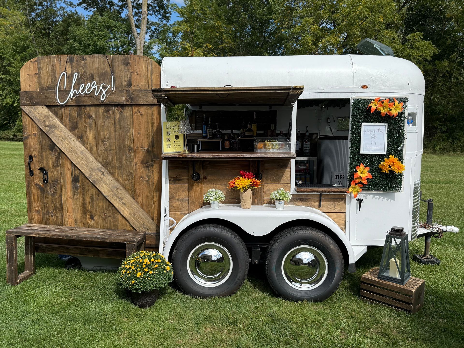 Cocktails in three glasses with straws on a decorated table, with sparkling champagne glasses in view.